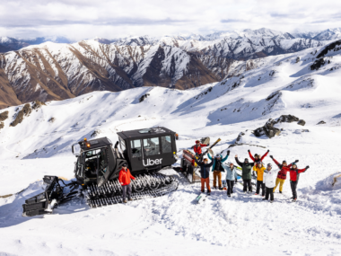 Skiers stand around an Uber snowcat at Soho Basin