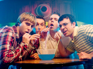 The four members of The Inbetweeners drinking out of one cocktail jug.