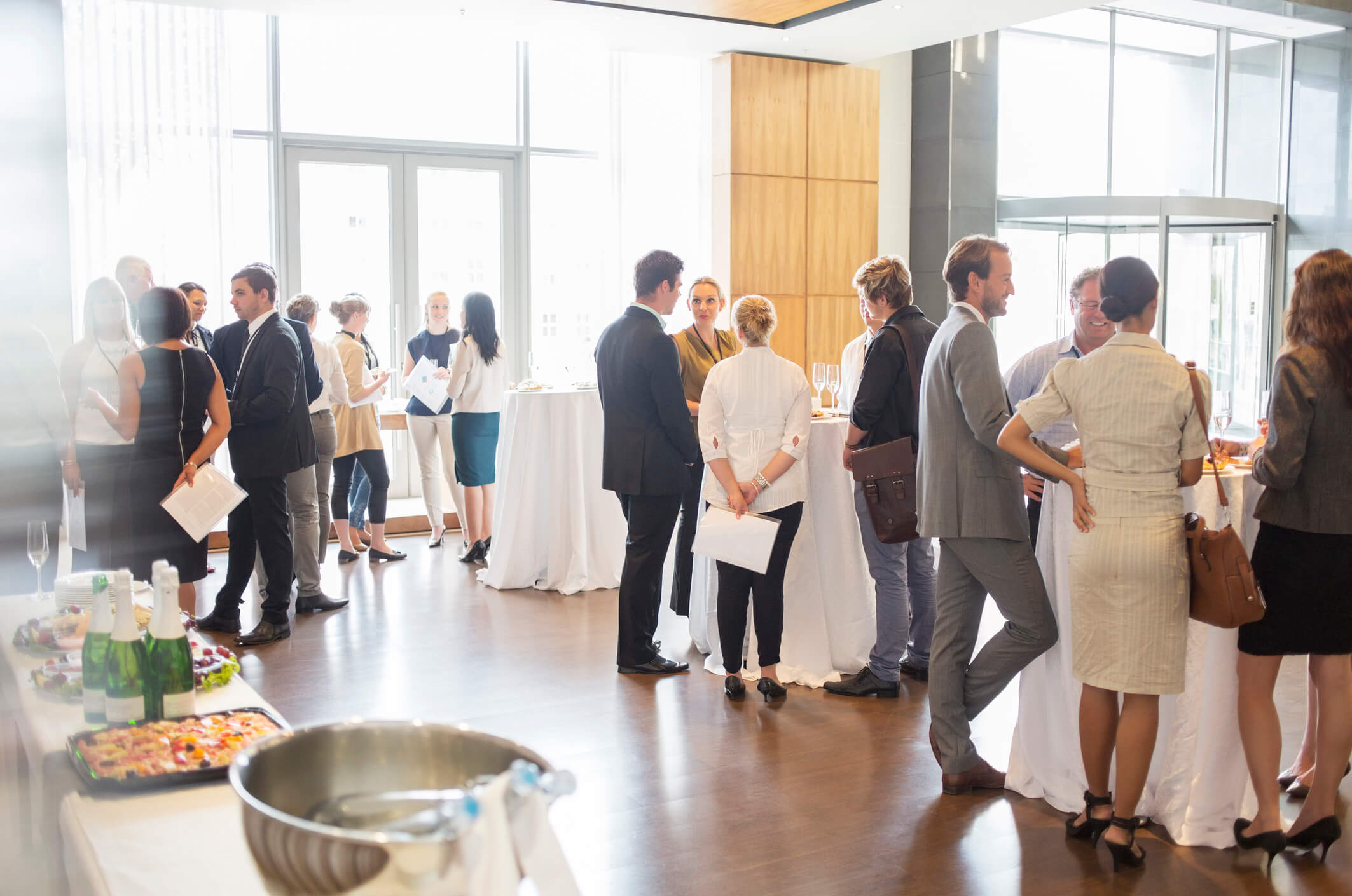 A conference of formally dressed people socializing and eating